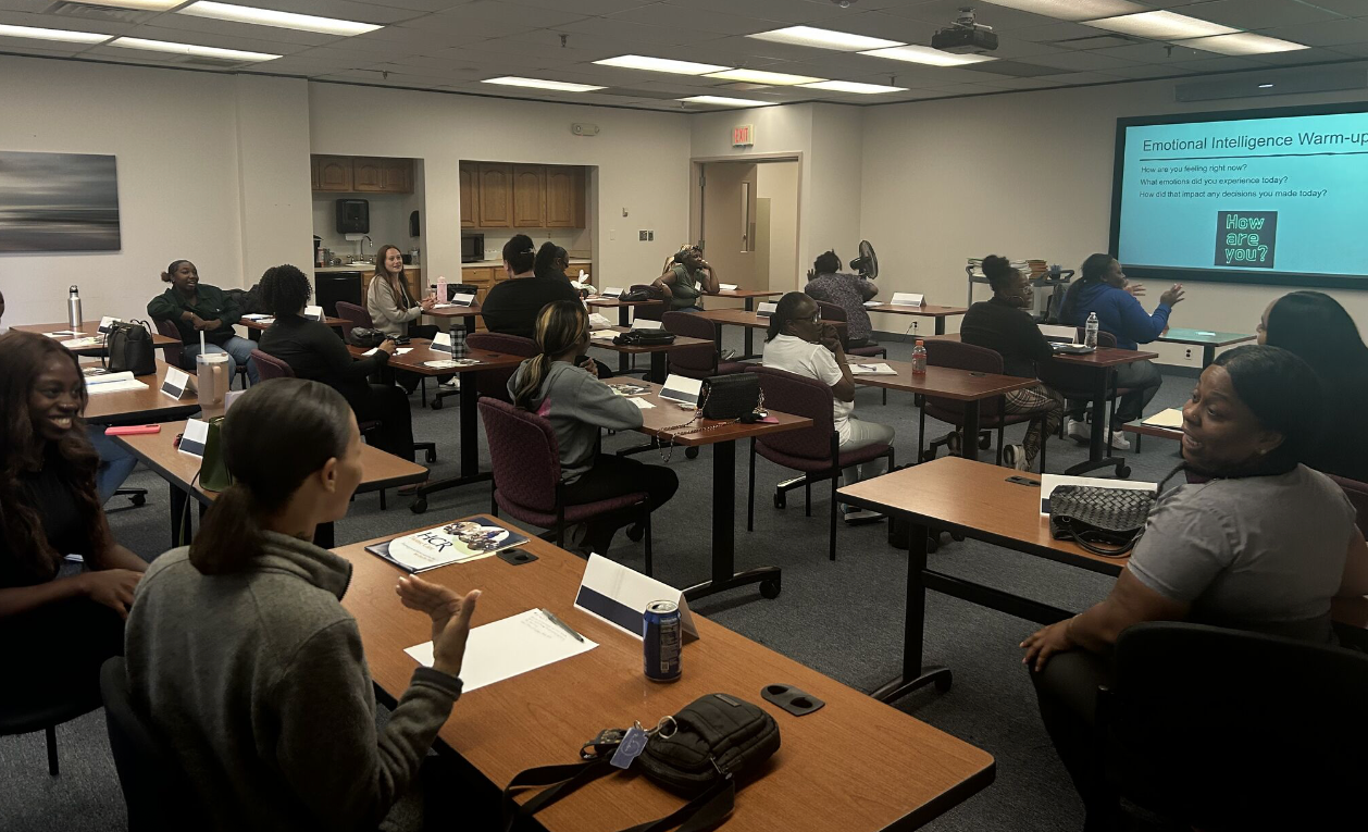 Adult education classroom with teacher motivating students